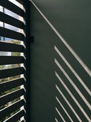 The background image of sunlight and shadows reflecting on the cement wall in diagonal lines...