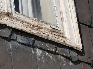 Old white wooden window frame in a listed building in need of renovation