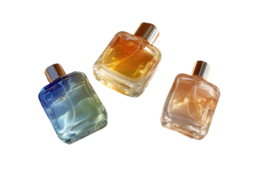 Three perfume bottles, varying colors, in mid-air