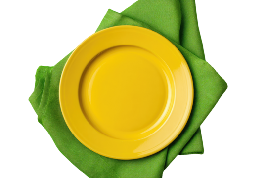 Empty yellow plate on a green napkin