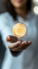 Woman Presenting Glowing Orange Digital Target Interface hand holding photo