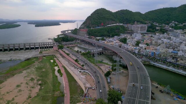 Aerial view of South Indian city Vijayawada shows bridges, flyovers and historic hindu godess Kanaka Durgha temple in the Andhra Pradesh state of India.