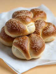 few bun rolls with sesame one on top of another on white cooking paper on light orange background, low angle shot, daylight professional food photography

https://s.mj.run/3WHcXp0Bdbo
https://s.mj.run