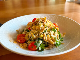 Rice with spinach, tomato and almond flakes served in plate. Healthy cuisine, nutrition, and vegetarian lifestyle highlighting wellness and culinary balance.