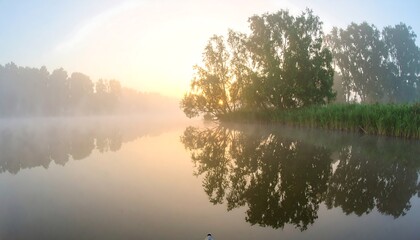 Misty sunrise over a calm river