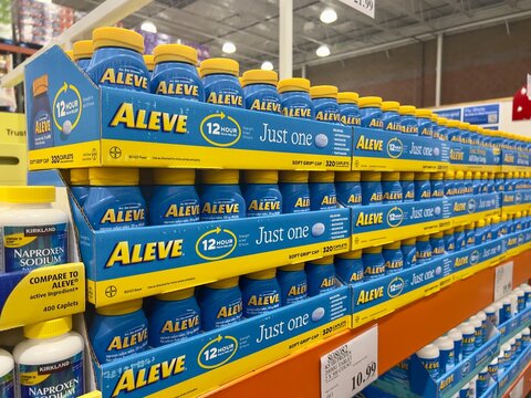 Plastic jars  of Aleve Naproxen sodium (NSAID) Pain reliever/fever reducer caplets for sale at a local Costco warehouse store