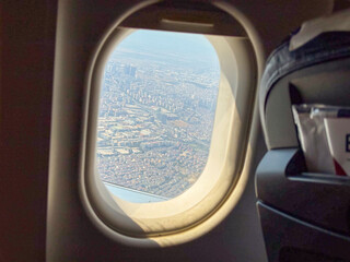 View from airplane window showing city and aircraft outside. Travel, aviation, and mobility symbolizing journey, tourism, and modern transportation.