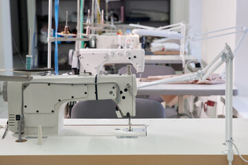 Row of sewing machines in atelier studio or tailor shop