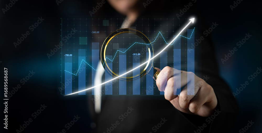 Poster a business professional evaluates financial data using a magnifying glass on graphs in a modern offi