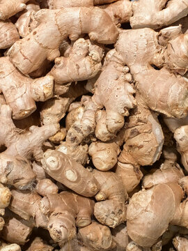 Pile of ginger roots on market counter