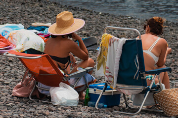 Friends sunbathing on a beach in the Canary Islands