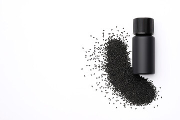 Black Bottle with Scattered Black Sesame Seeds on White Background with Copy Space