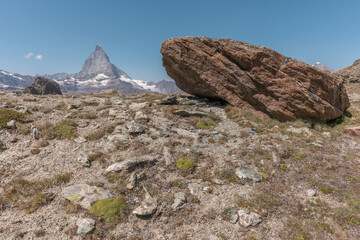 Majestic Matterhorn rises above rocky terrain in breathtaking alpine landscape during clear day