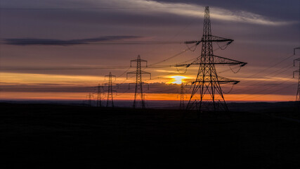 Power Lines on Countryside Landscape During a Vibrant Sunrise