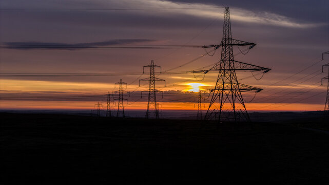 Power Lines on Countryside Landscape During a Vibrant Sunrise - Powered by Adobe