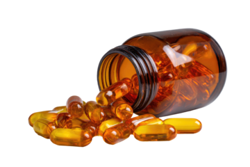 Amber glass jar spilling golden capsules