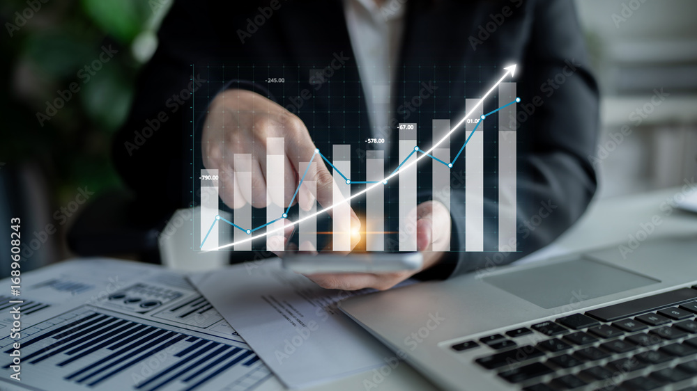 Poster a business professional analyzes financial growth data using graphs and charts displayed on a laptop
