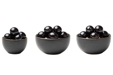Three dark bowls filled with plump, dark-colored fruit