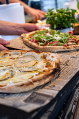 Freshly baked homemade pizza with crispy crust, aromatic toppings, and rustic presentation, served in a cozy restaurant setting for a delightful dining experience