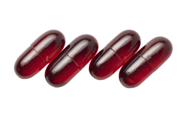 Close-up of three translucent, reddish-maroon capsules arranged in a wavy pattern against a black background.  The capsules appear smooth and glossy, with visible interior outlines
