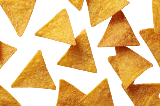 Scattered triangular tortilla chips.  Close-up view of many golden-yellow corn chips,  arranged in a random pattern.  The chips are crisp and appear freshly made