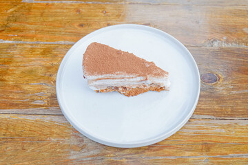 Enjoy a delicious slice of tiramisu cake, a perfect indulgence for dessert lovers and cafe enthusiasts