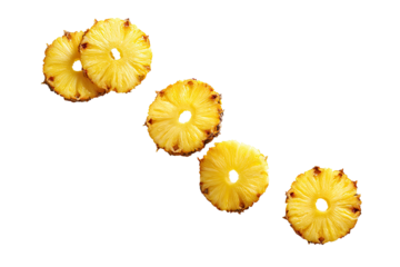 Four sliced pineapple rings, arranged diagonally against a black background.  The rings are a vibrant yellow with visible, slightly browned edges and a central hole