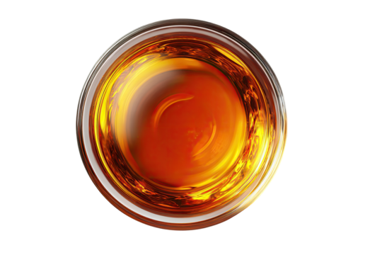 Overhead view of a round glass bowl filled with amber liquid, showcasing swirling patterns within