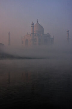 View of Taj Mahal reflected in Yamuna river with early morning fog, Agra, Uttar Pradesh, India