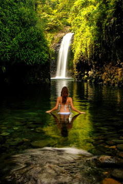 Young woman in bikini standing at Wainibau Waterfall on Taveuni Island, Fiji