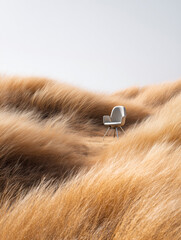 An image of a white armchair in tall grass, with the sky and wind in the background.