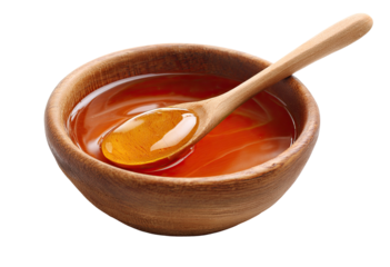 Honey in a wooden bowl with a spoon
