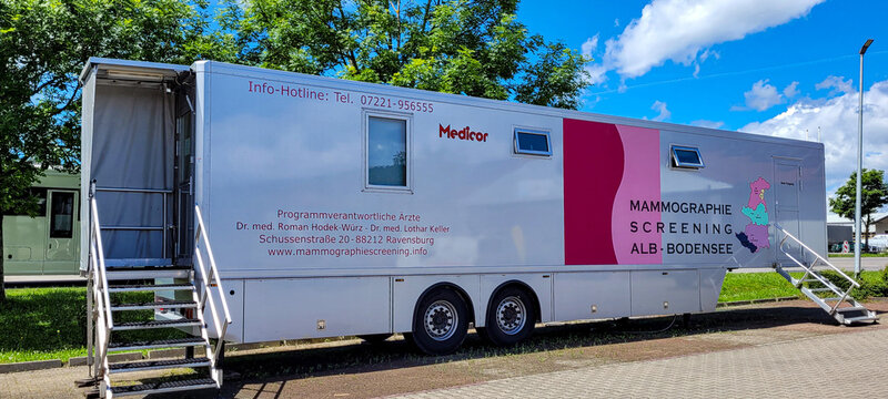 Mobile mammography screening station Alb - Bodensee against the backdrop of green trees, blue sky and white clouds. Breast screening service. May 28, 2024. Markdorf, Baden-Wuerttemberg, Germany