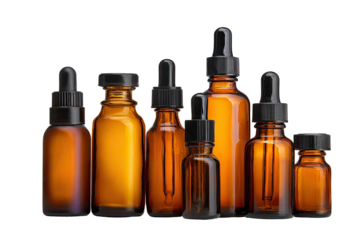 Amber glass bottles with droppers.  Various sizes and shapes, against a black background