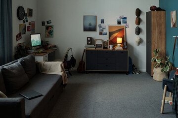 Modern living room showing digital tablet on sofa and desktop computer on desk emphasizing gadget addiction concept