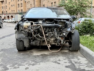 The car was seriously damaged as a result of a recent collision and a traffic accident. This close-up image shows a car with extensive damage to the front as a result of a serious accident