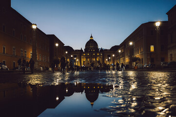Panoramic night view of St Peter's Basilica with beautiful reflection in Vatican City. Architecture, landmark and attractions of Rome, Italy. High quality photo