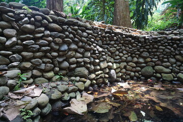 The walls of a pool are made of round river stones arranged in such a way that it looks beautiful...