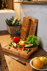 Colorful vegetables and avocado on a wooden board in a cozy festive kitchen