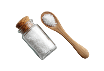 Small glass jar and wooden spoon filled with coarse sea salt