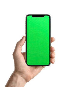 A hand holding a smartphone with a green screen
