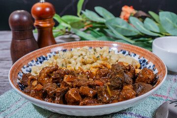 Delicious hungarian goulash with spaetzle on a decorated plate