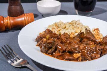 Delicious hungarian goulash with spaetzle served on white plate