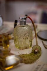 A beautiful arched perfume bottle connected to a hose with a pump bulb.
