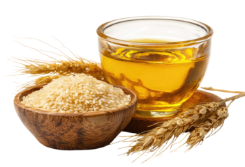 Wheat, rice, and oil. A small bowl of light brown rice sits beside a small clear glass cup of golden oil. Wheat stalks frame the bowl and cup
