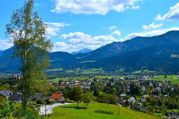 Fototapeta premium View of Greifenburg town in Drautal valley bellow Geiltaler alps mountain range covered in forest in Carinthia, Austria