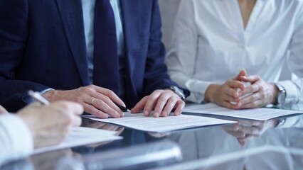 Business people and lawyers a contract papers before signing the agreement. Teamwork concept