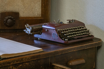 An old retro typewriter on an old wooden table.
