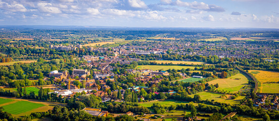 Aerial view of Windsor Castle surrounded by town buildings and lush green landscape