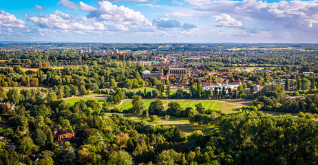 Aerial view of Windsor Castle surrounded by town buildings and lush green landscape